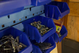 Stacked shelves filled with nails, screws, and bolts in organized bins at Voltcraft Hardware.