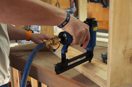 a person using a power drill on a piece of wood