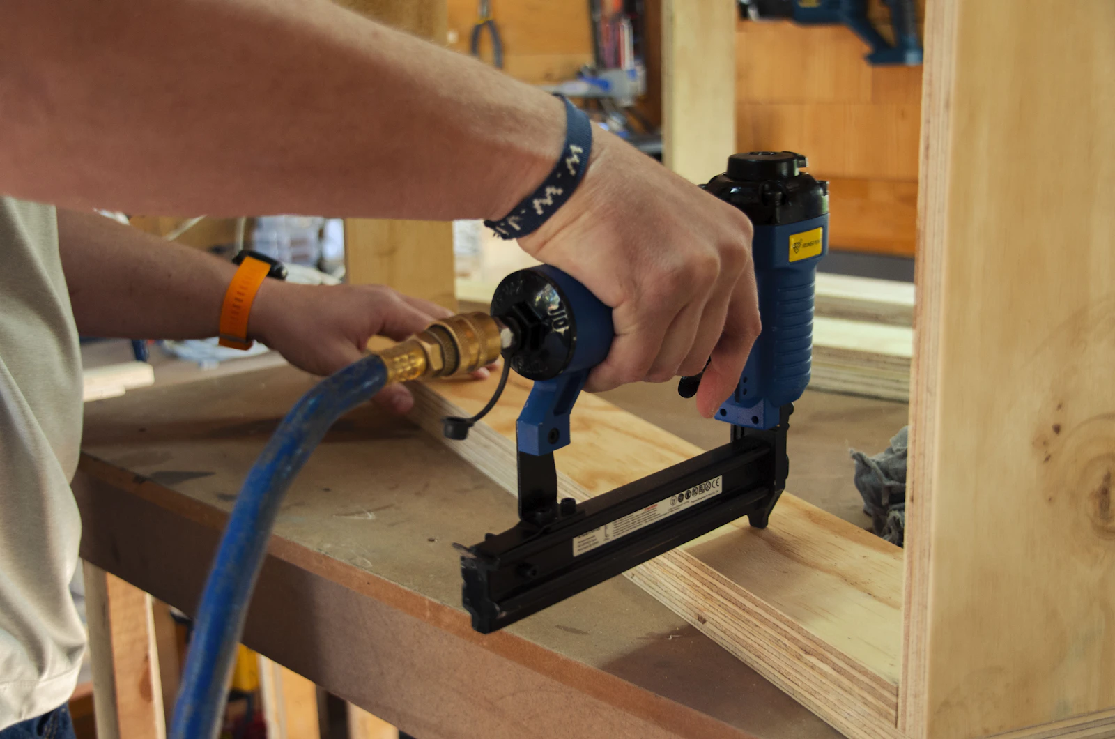 Fastening tool being used on a woodworking project in a workshop