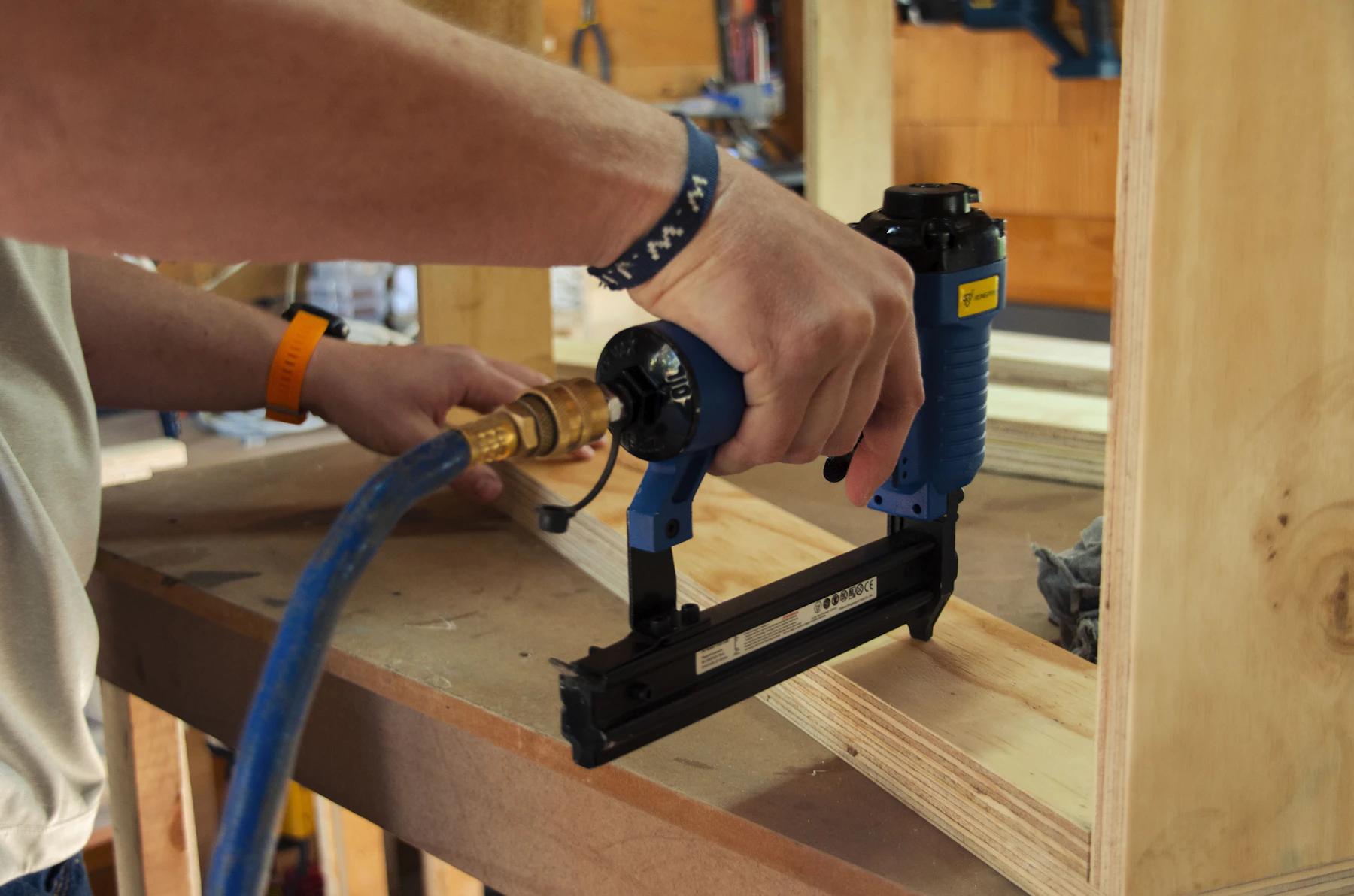 Power fastening equipment in use during a workshop project with organized tools nearby
