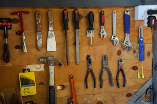 a bunch of tools are hanging on a wall