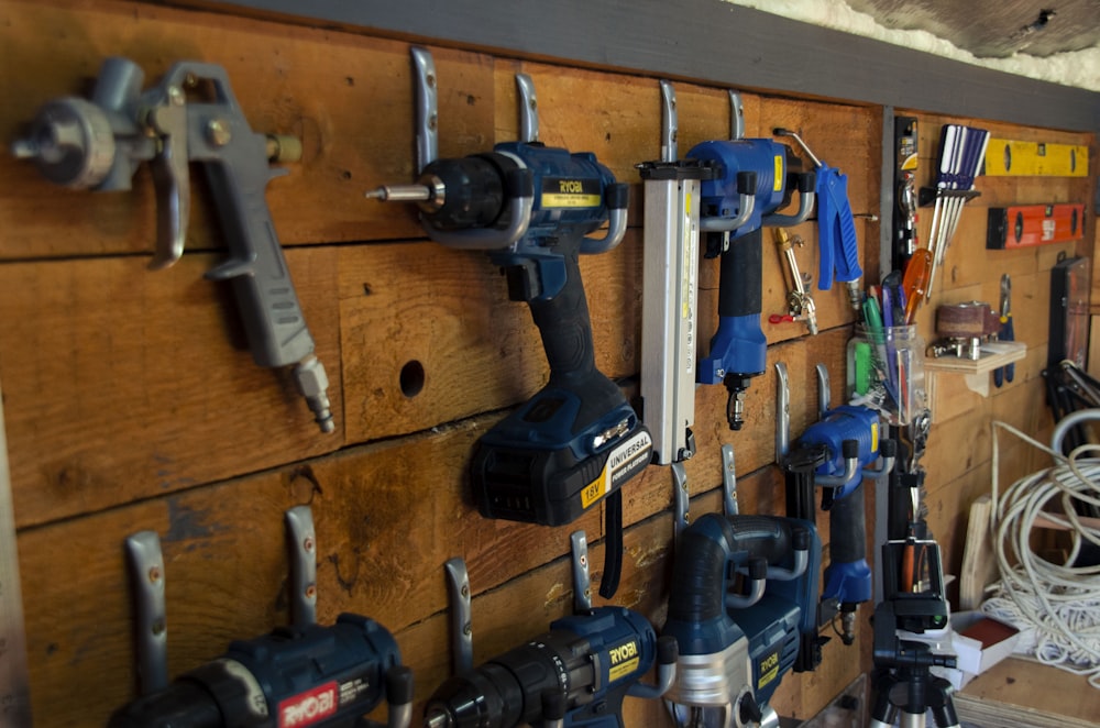 a bunch of tools are hanging on a wall