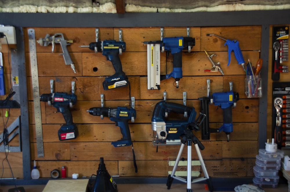 a wooden wall with tools hanging on it