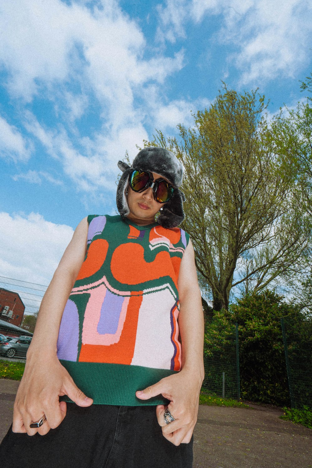 a woman wearing a colorful top and sunglasses