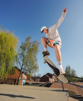 Dynamic shot of a skateboarder mid-trick in slate grey joggers and a minimalist tee.