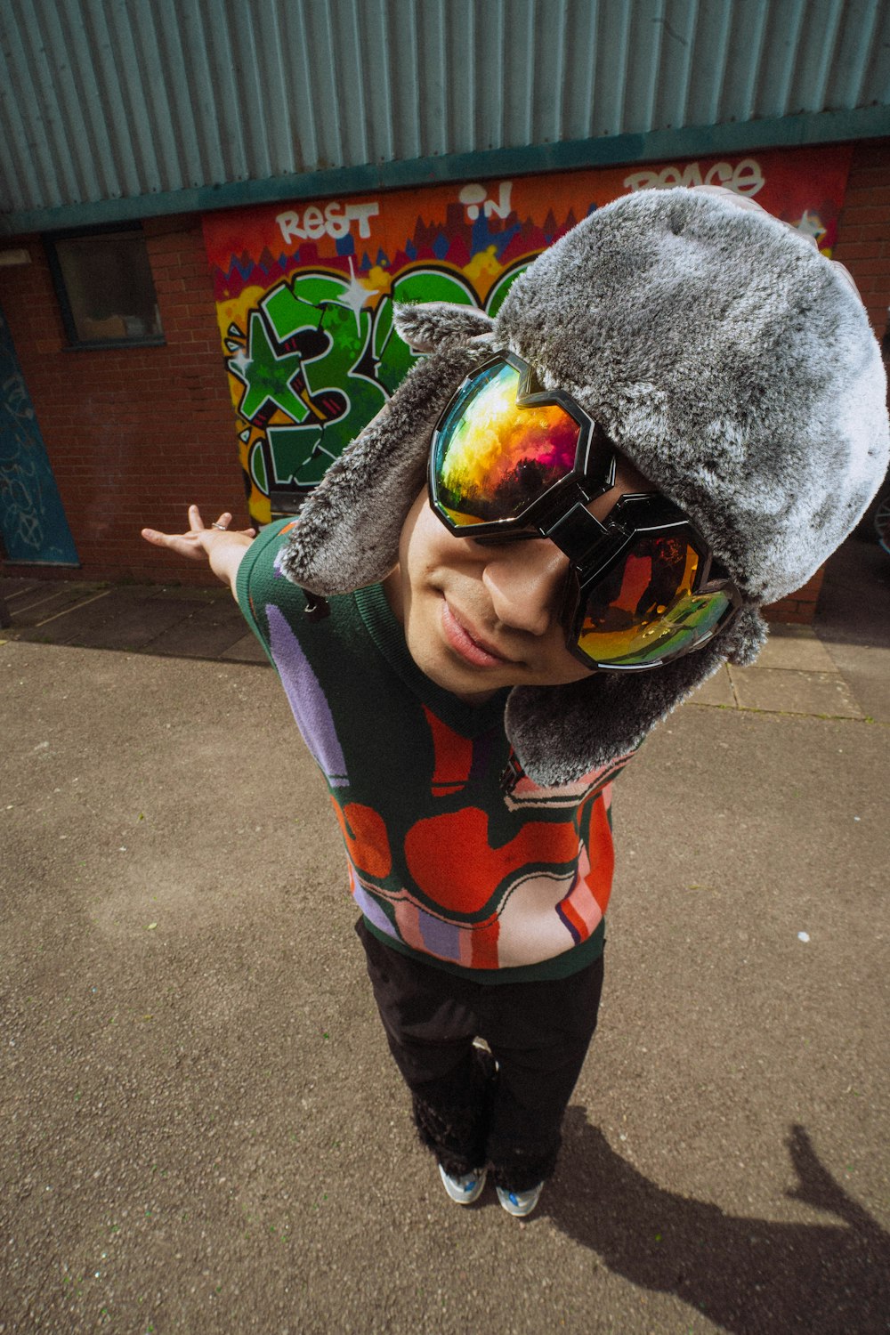 a young boy wearing sunglasses and a hat
