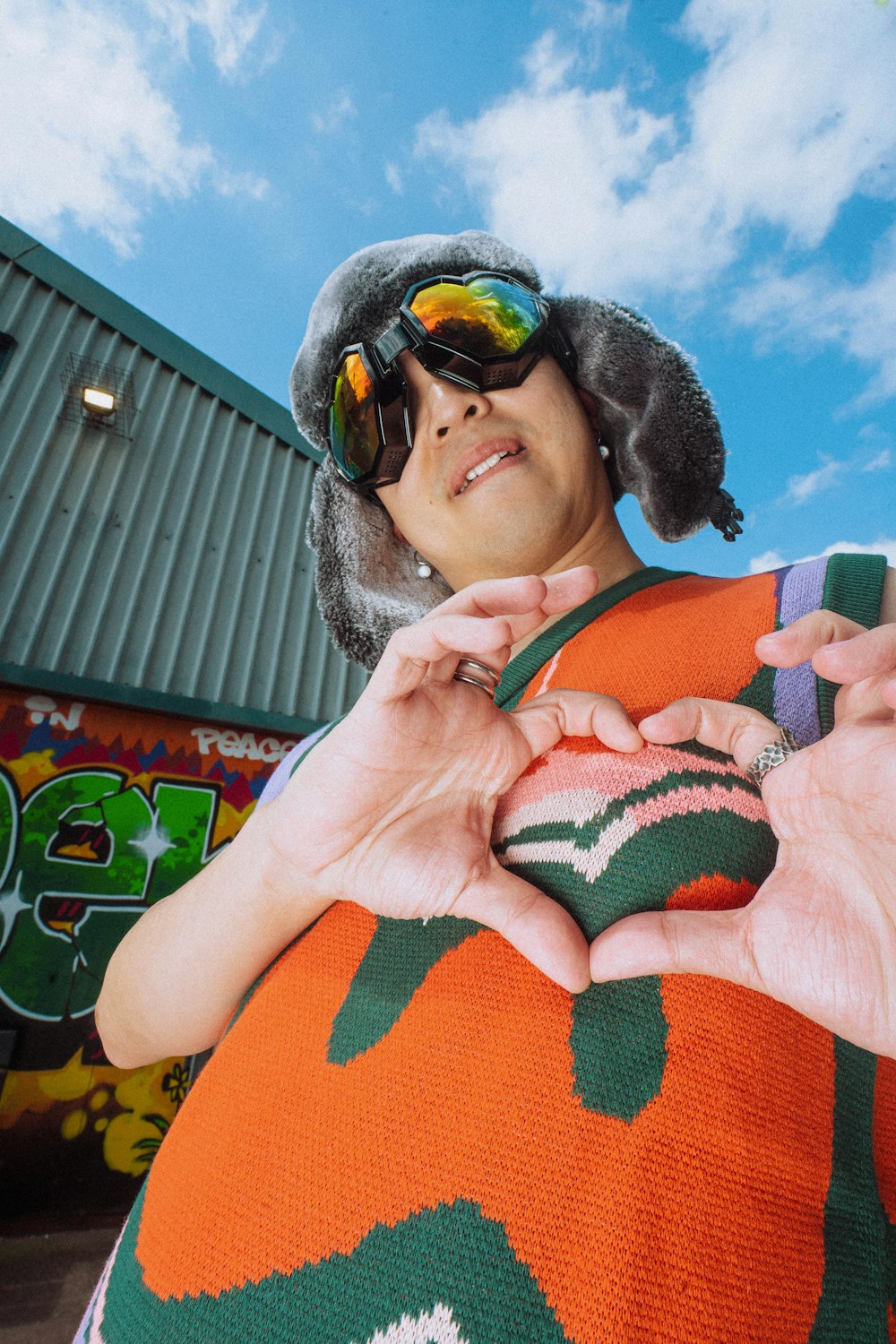 a woman wearing sunglasses and a knitted sweater