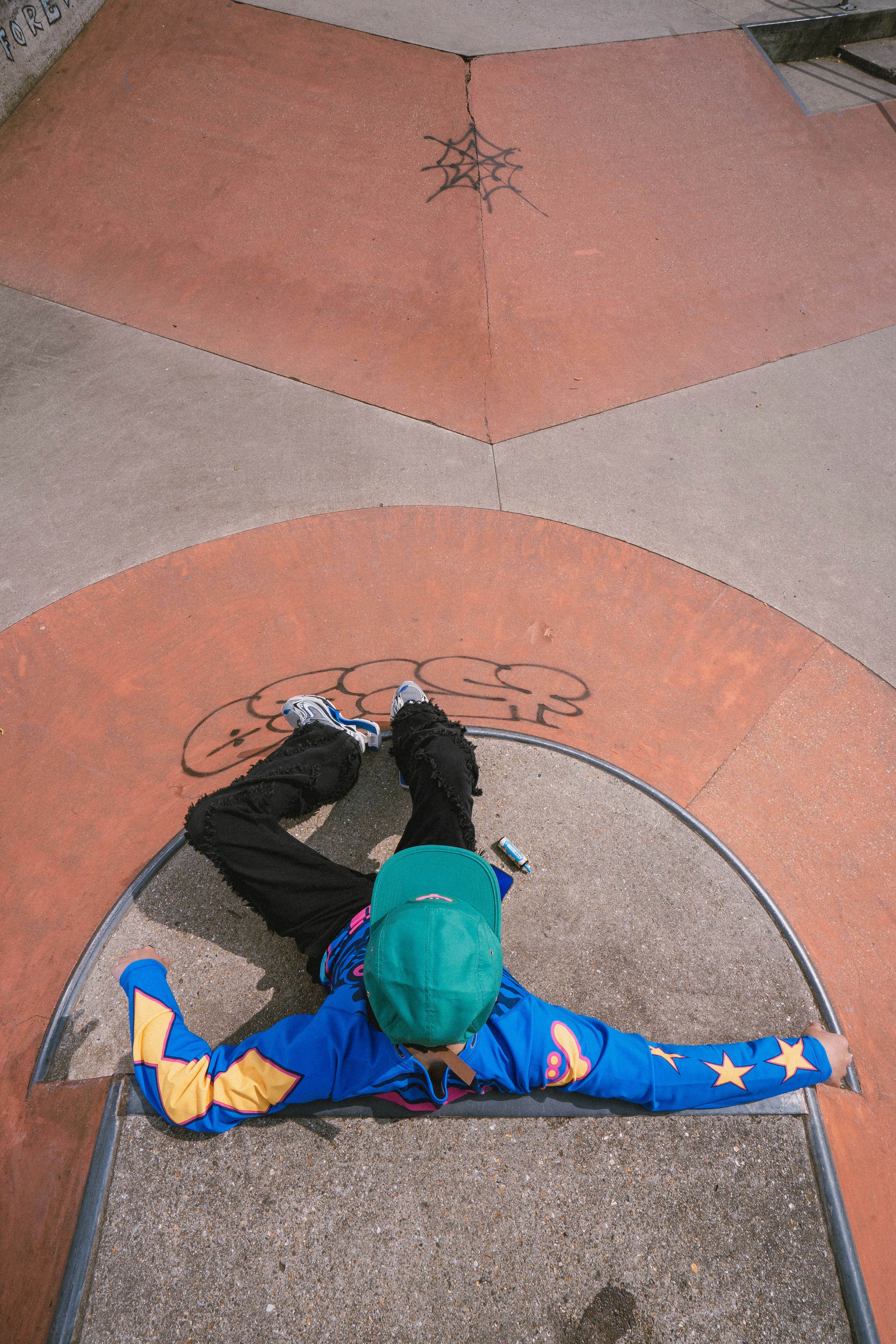a person laying on the ground on a skateboard