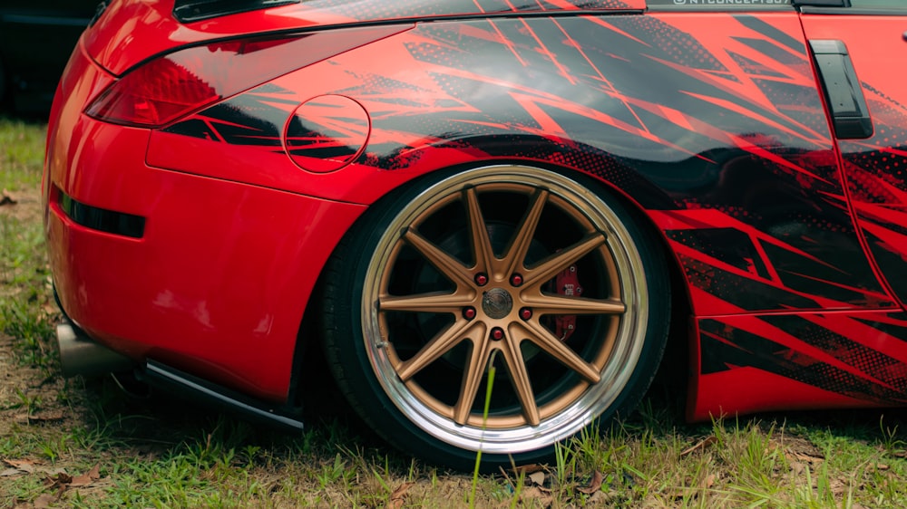 a red sports car parked in the grass