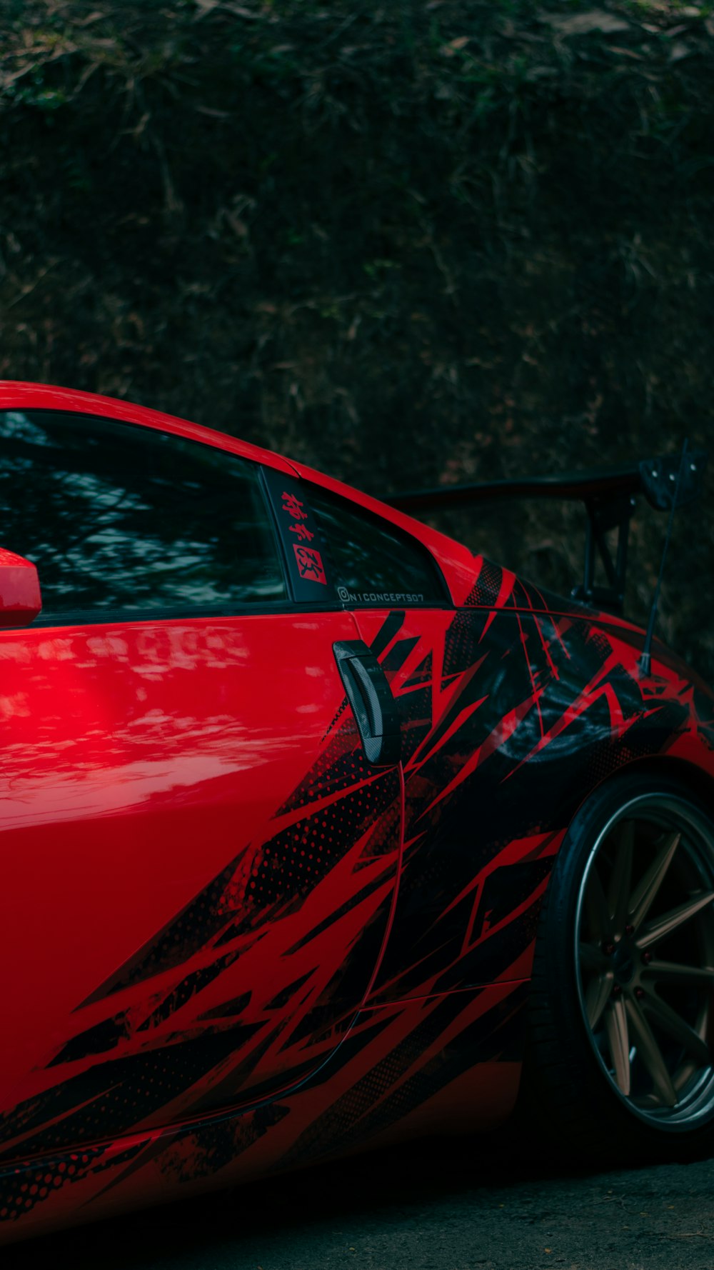 a red sports car parked on the side of the road