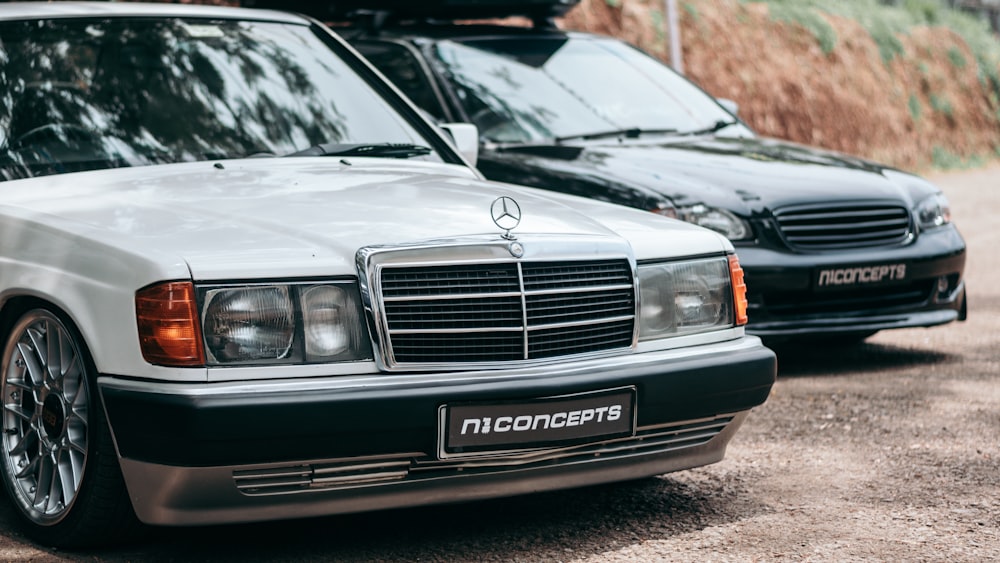 two mercedes benzs parked next to each other