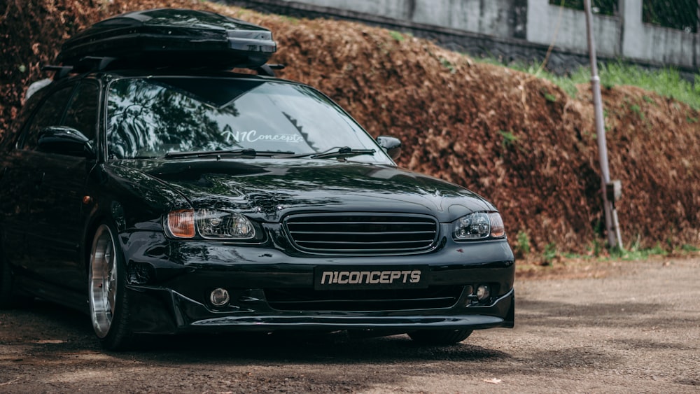 a black car with a surfboard on top of it