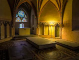 A peaceful chapel interior with soft light filtering through stained glass.