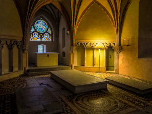 A quiet chapel interior with stained glass windows casting colorful light