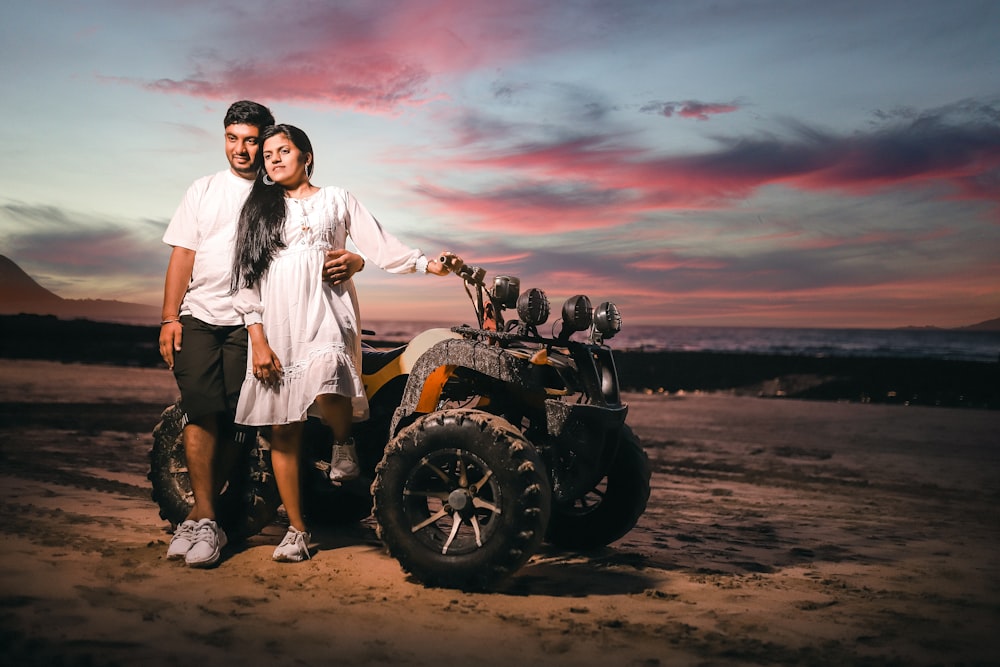 a man and woman standing next to an atv