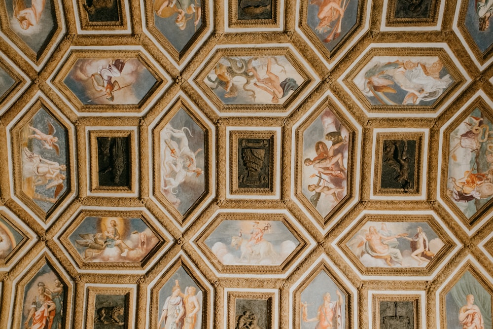 the ceiling of a room with many paintings on it