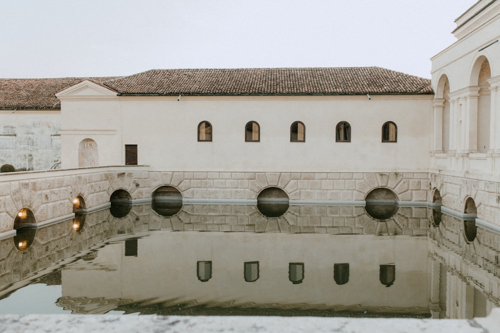 a reflection of a building in a pool of water