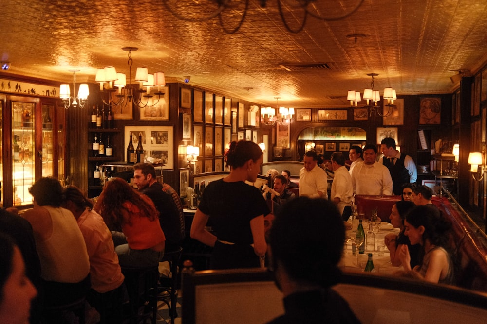 a group of people sitting at tables in a restaurant