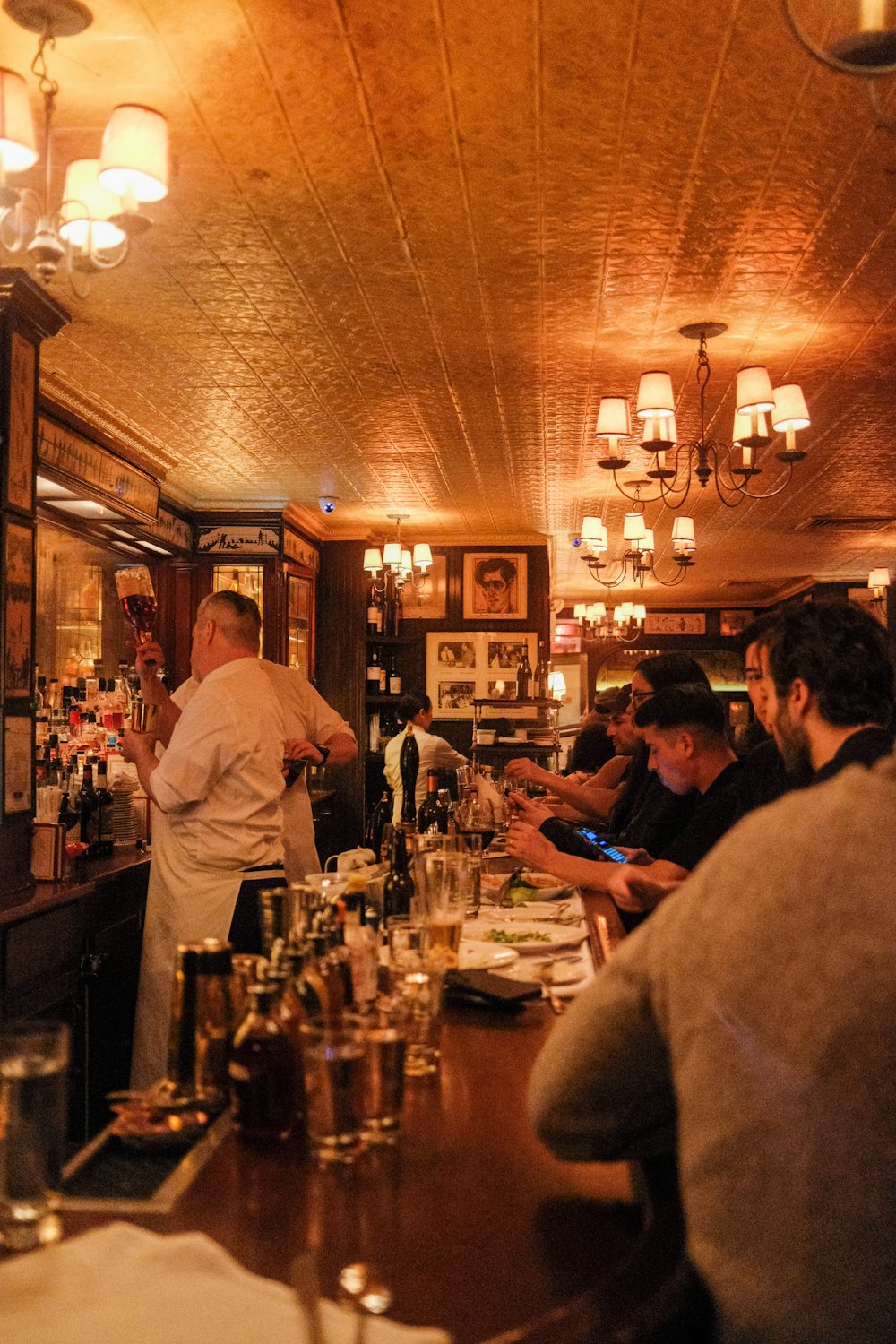 a group of people sitting at a bar