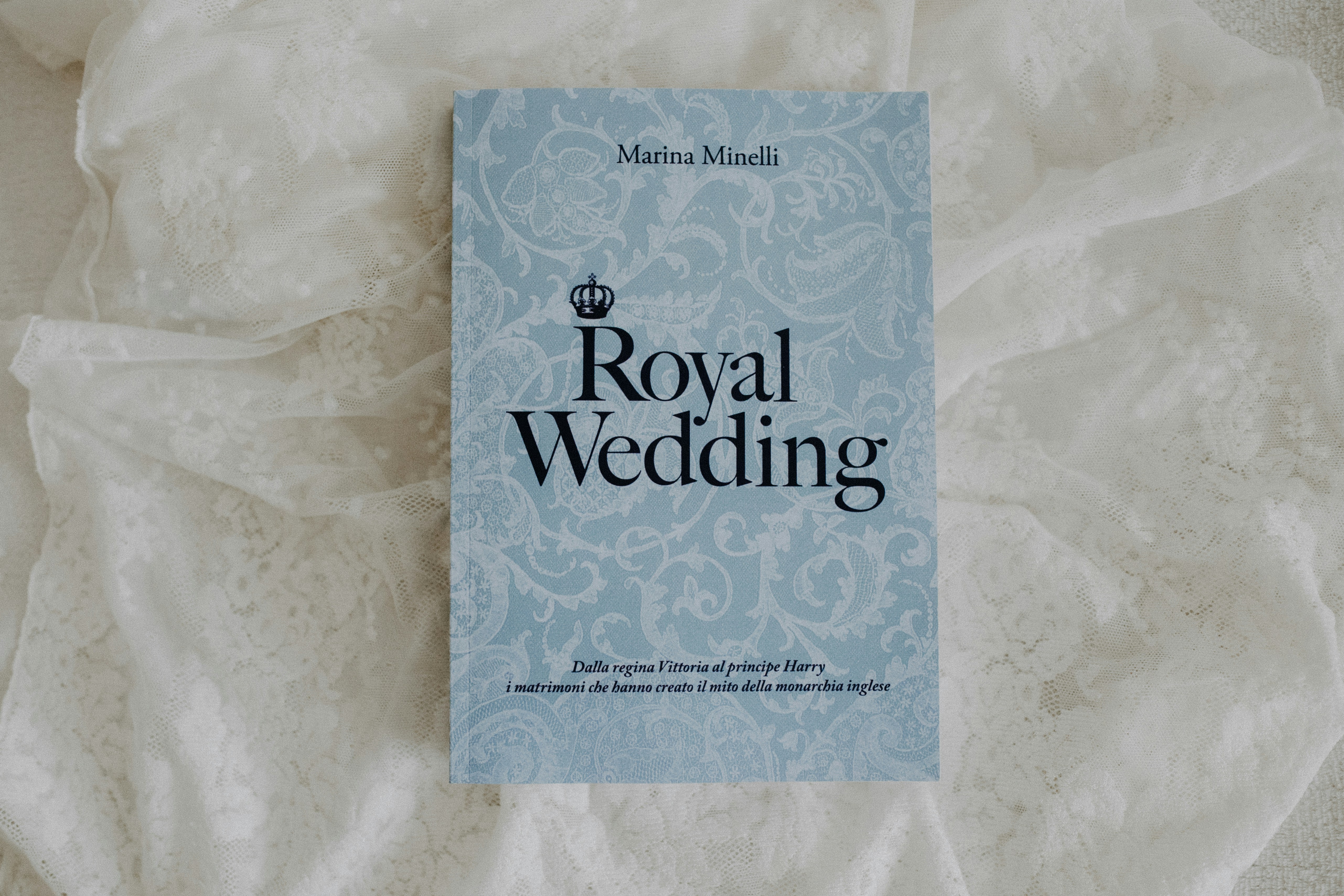 ein blaues Buch, das auf einem weißen Blatt sitzt