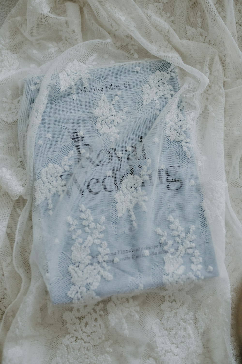 a royal wedding book laying on a bed