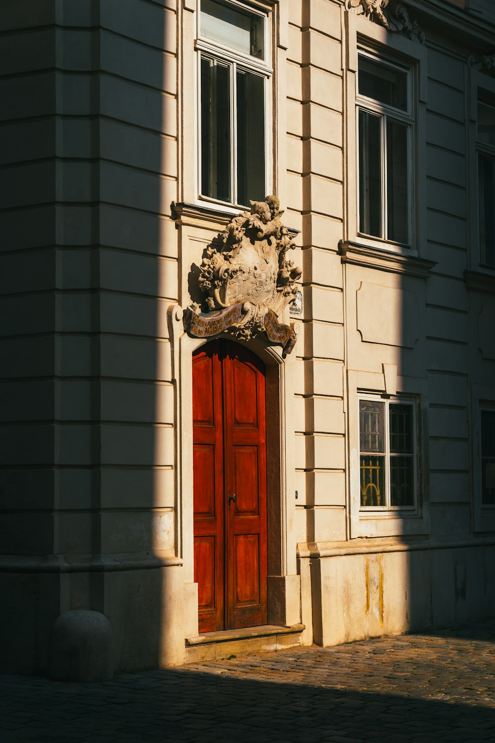 a large building with a red door and window