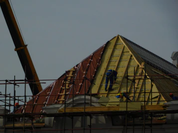 A team of construction workers collaborating on a residential building site in Ecuador.
