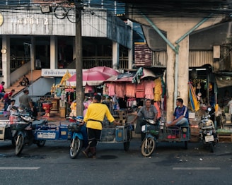 a group of people riding motorcycles down a street