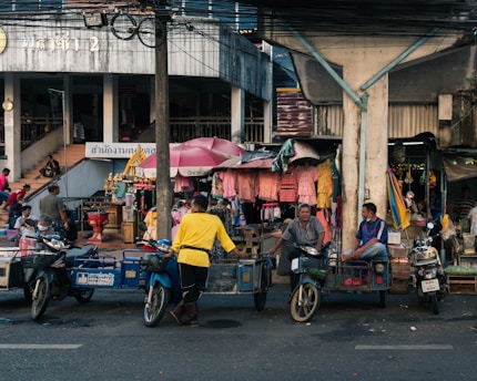 a group of people riding motorcycles down a street