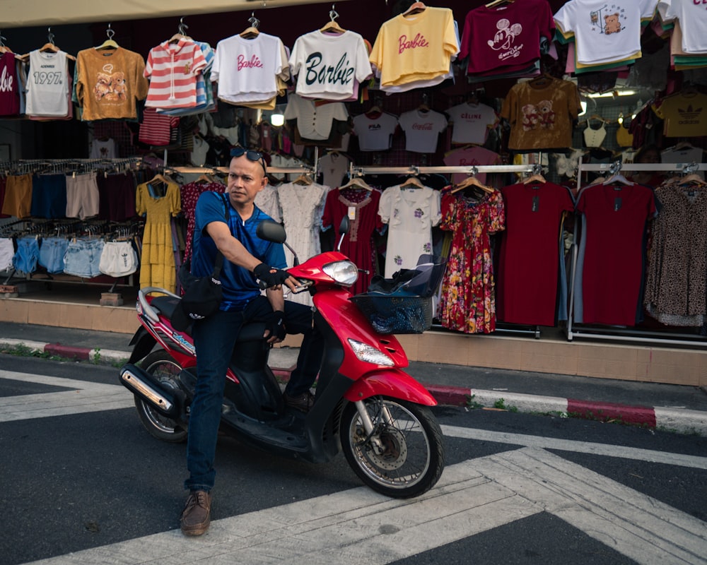 a man sitting on a scooter in front of a store