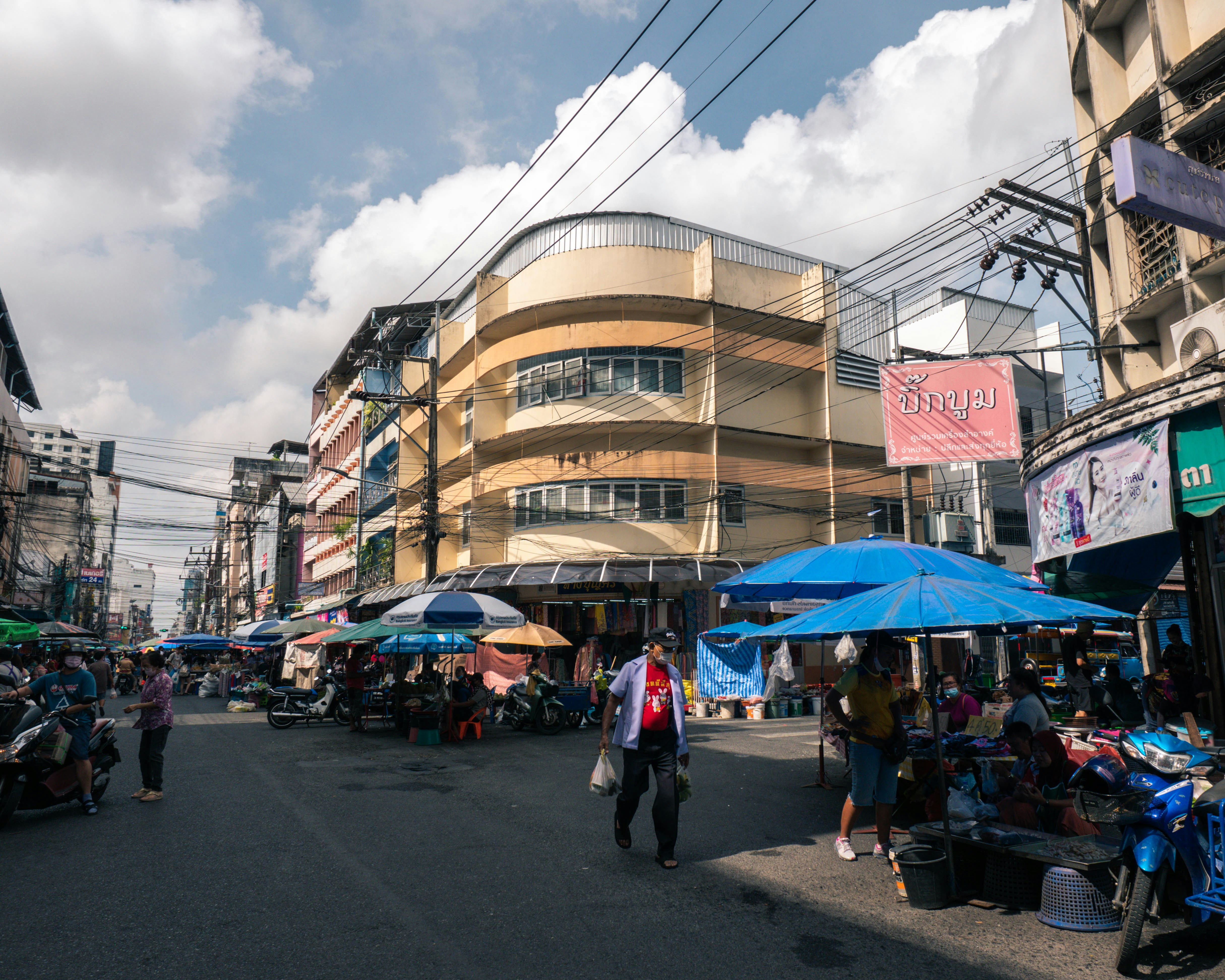a city street filled with lots of people and umbrellas