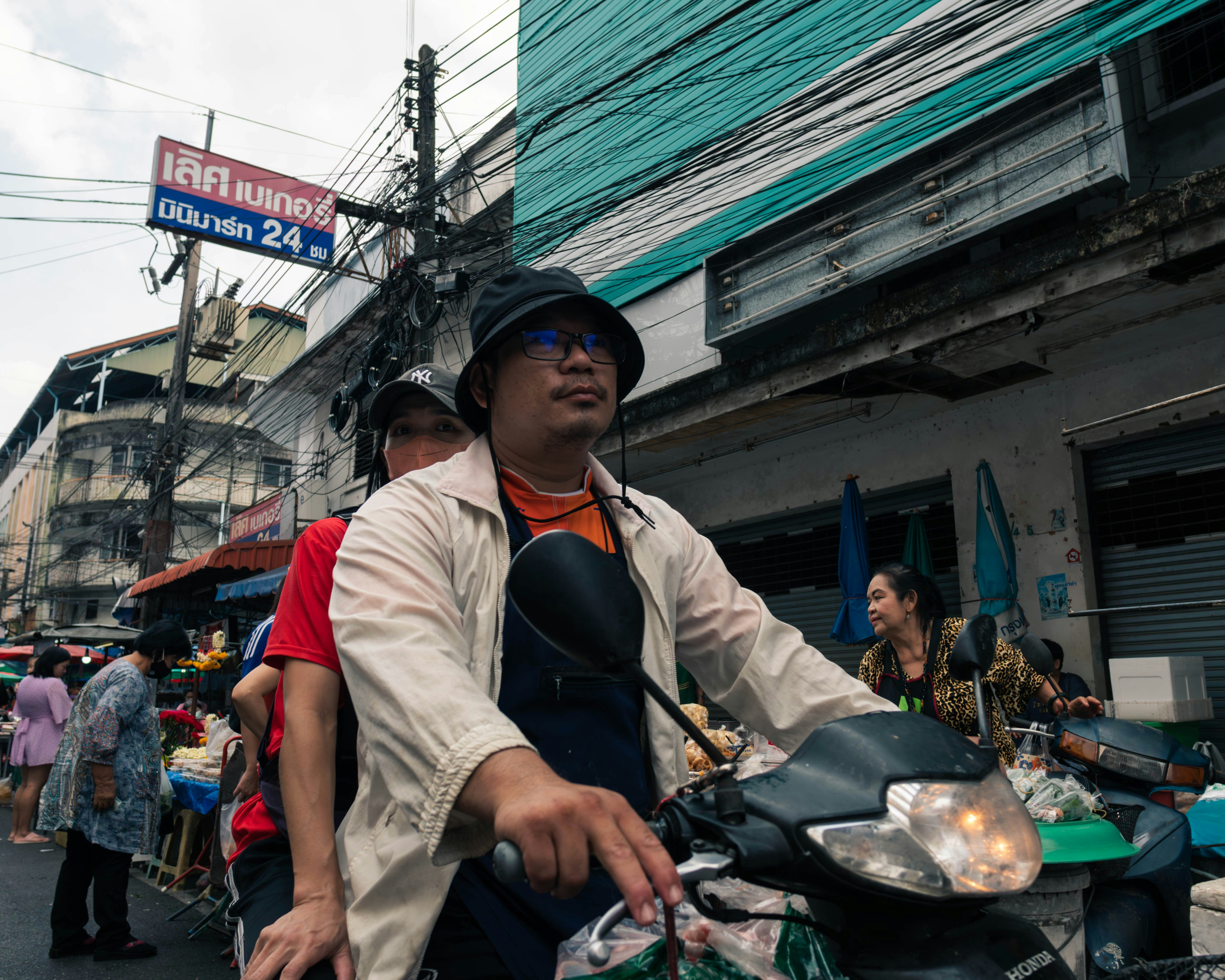a man riding on the back of a motorcycle down a street