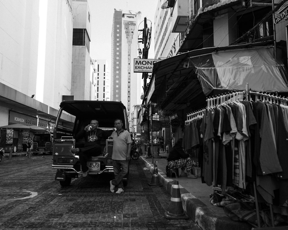 a black and white photo of a man walking down a street