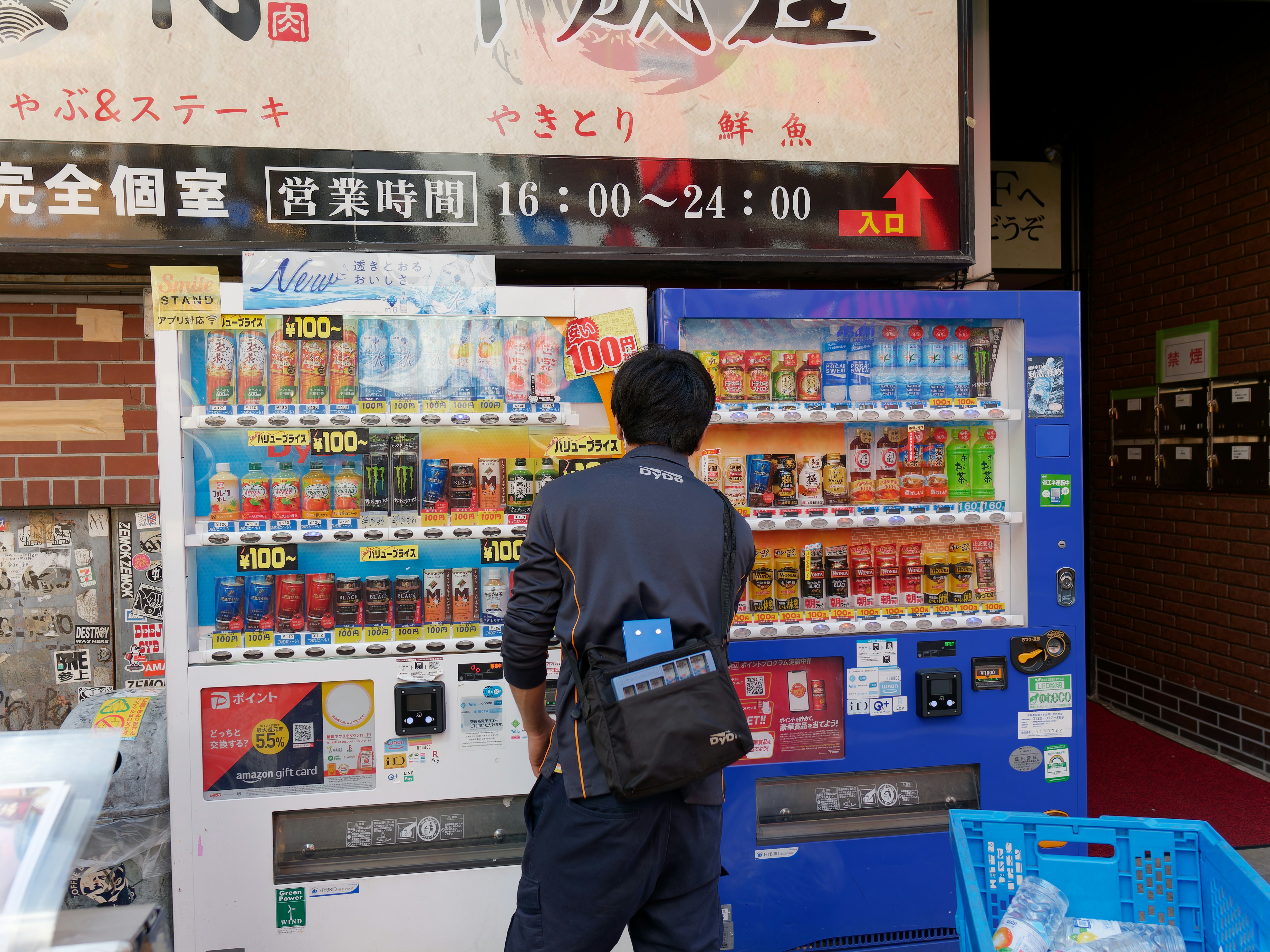 Japanese convenience store cashier warming up food for a customer at the counter