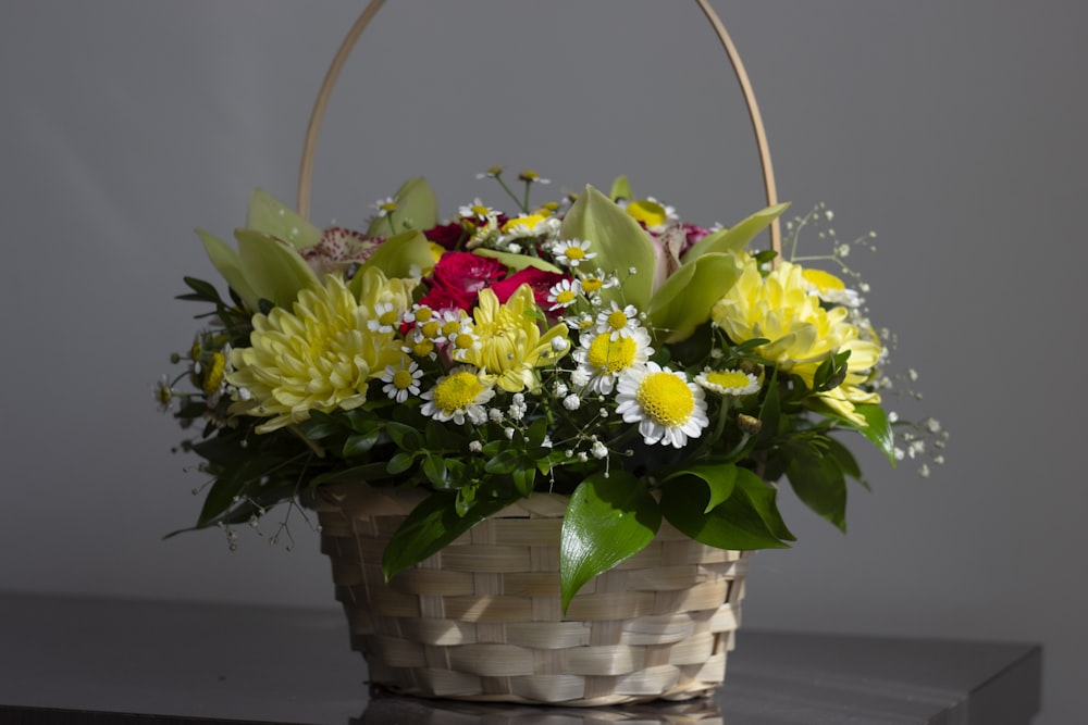 a basket filled with flowers sitting on top of a table