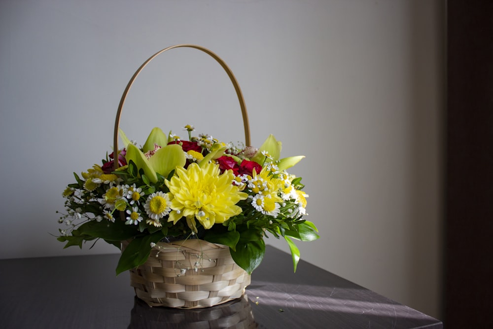 a basket filled with flowers sitting on top of a table