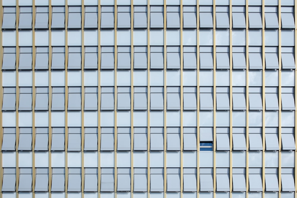 a tall building with many windows and a sky background