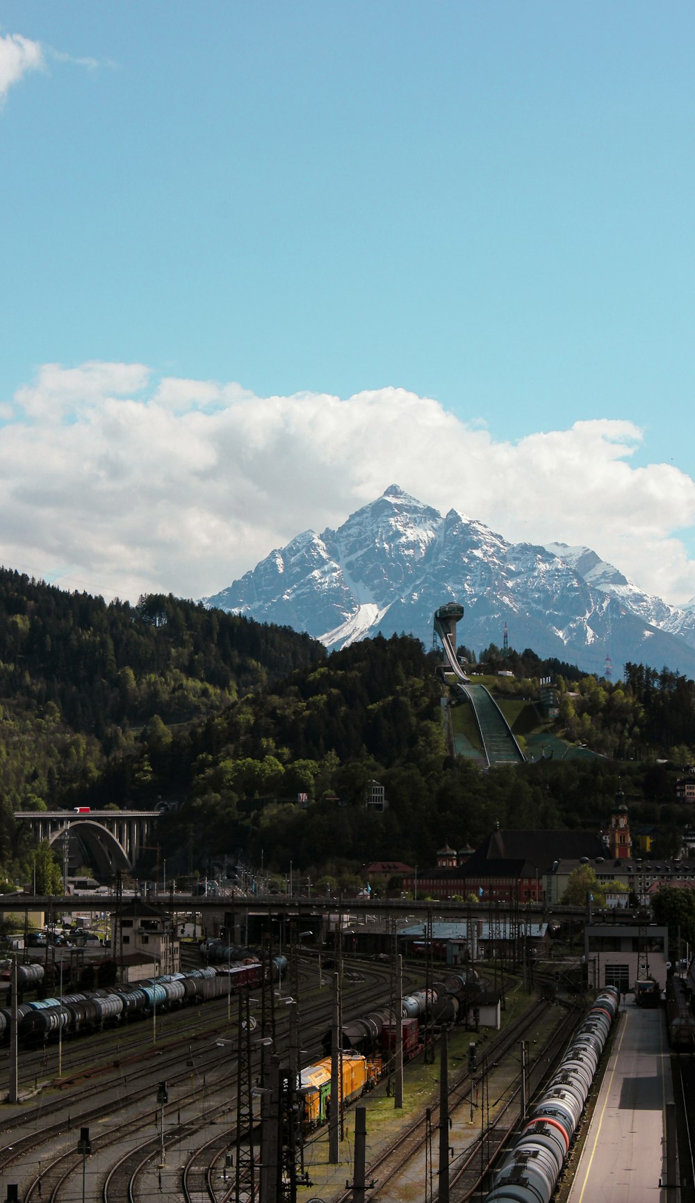 a train station with a mountain in the background