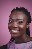 a woman with braids smiling at the camera