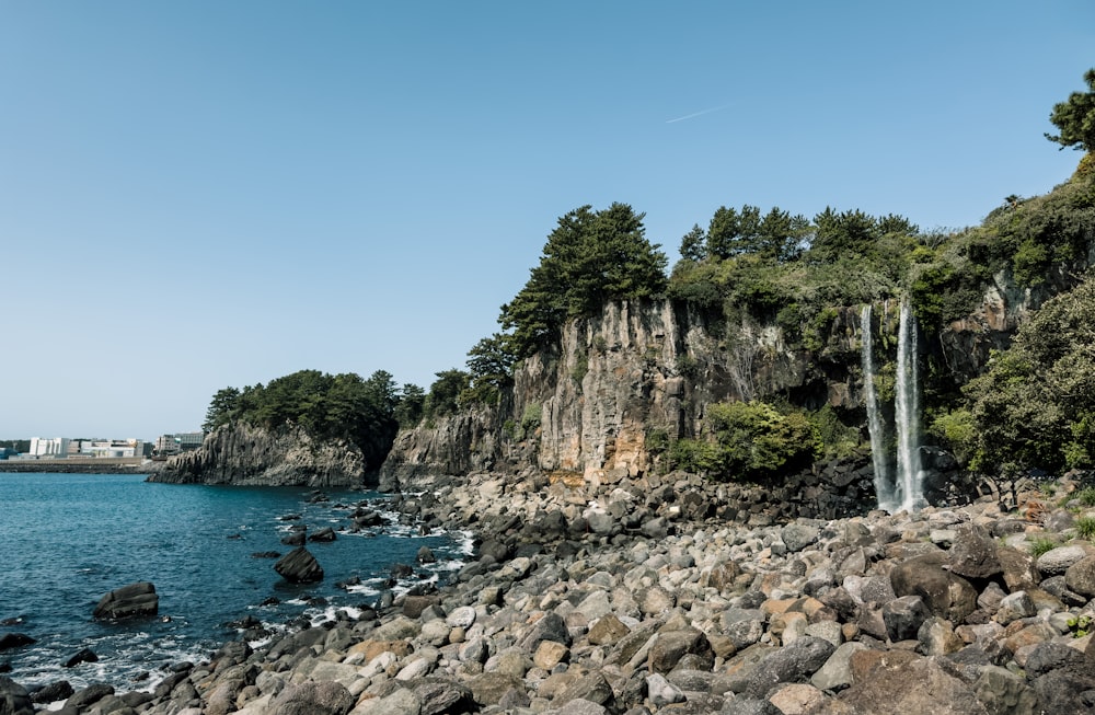 a large body of water surrounded by rocks and trees
