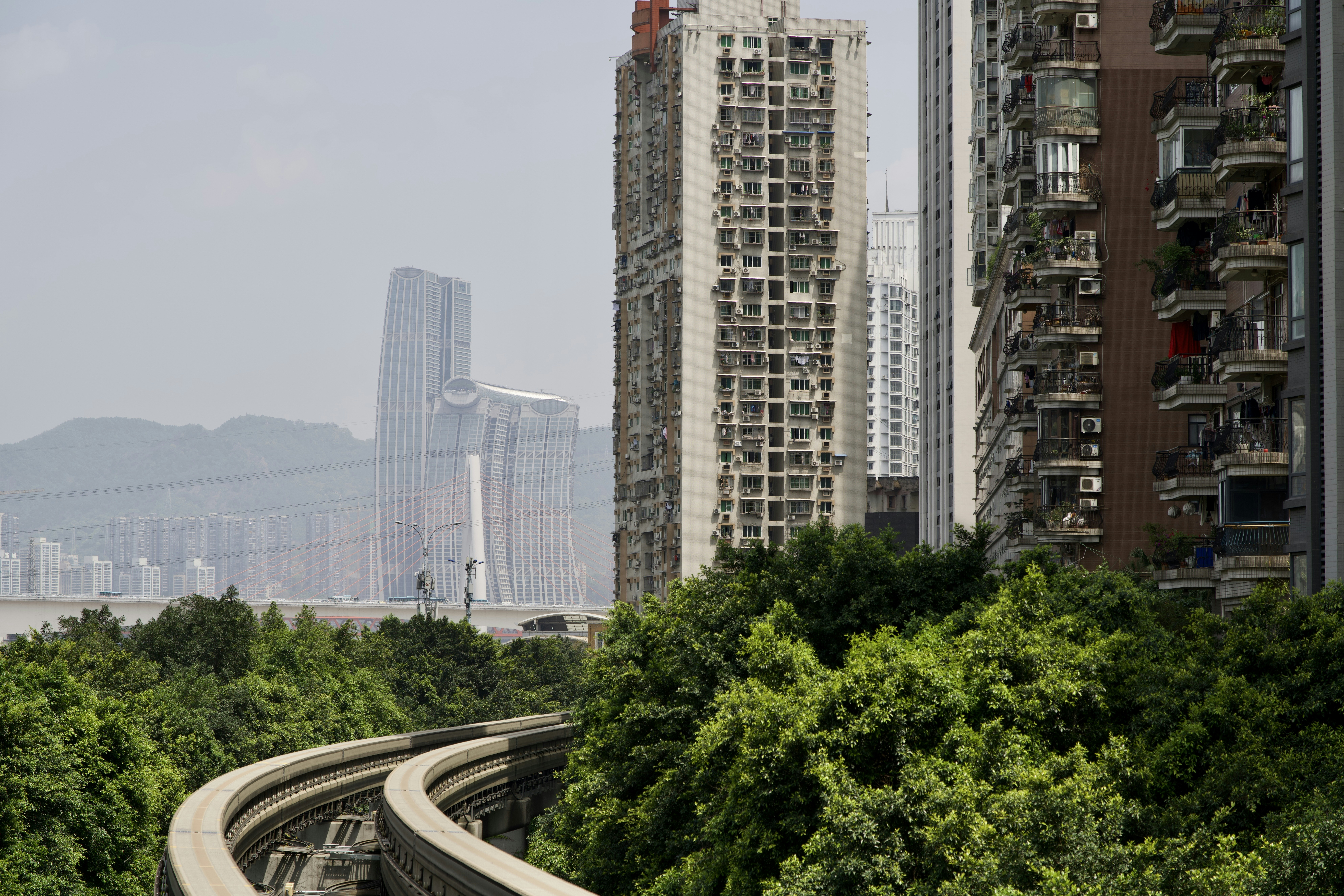 A train traveling through a city next to tall buildings photo – Free ...