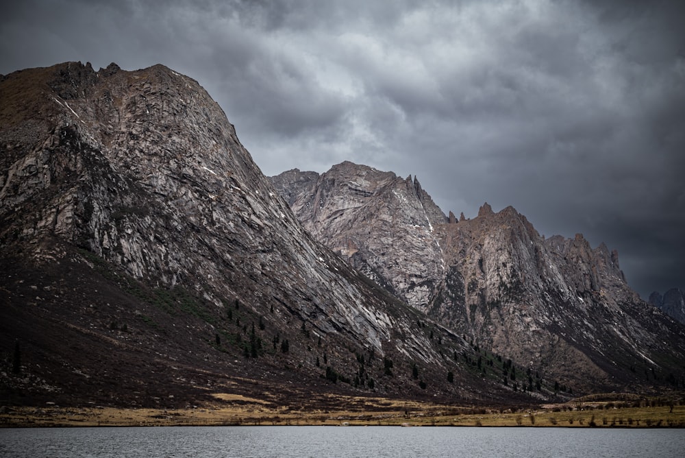 a mountain range with a body of water in front of it