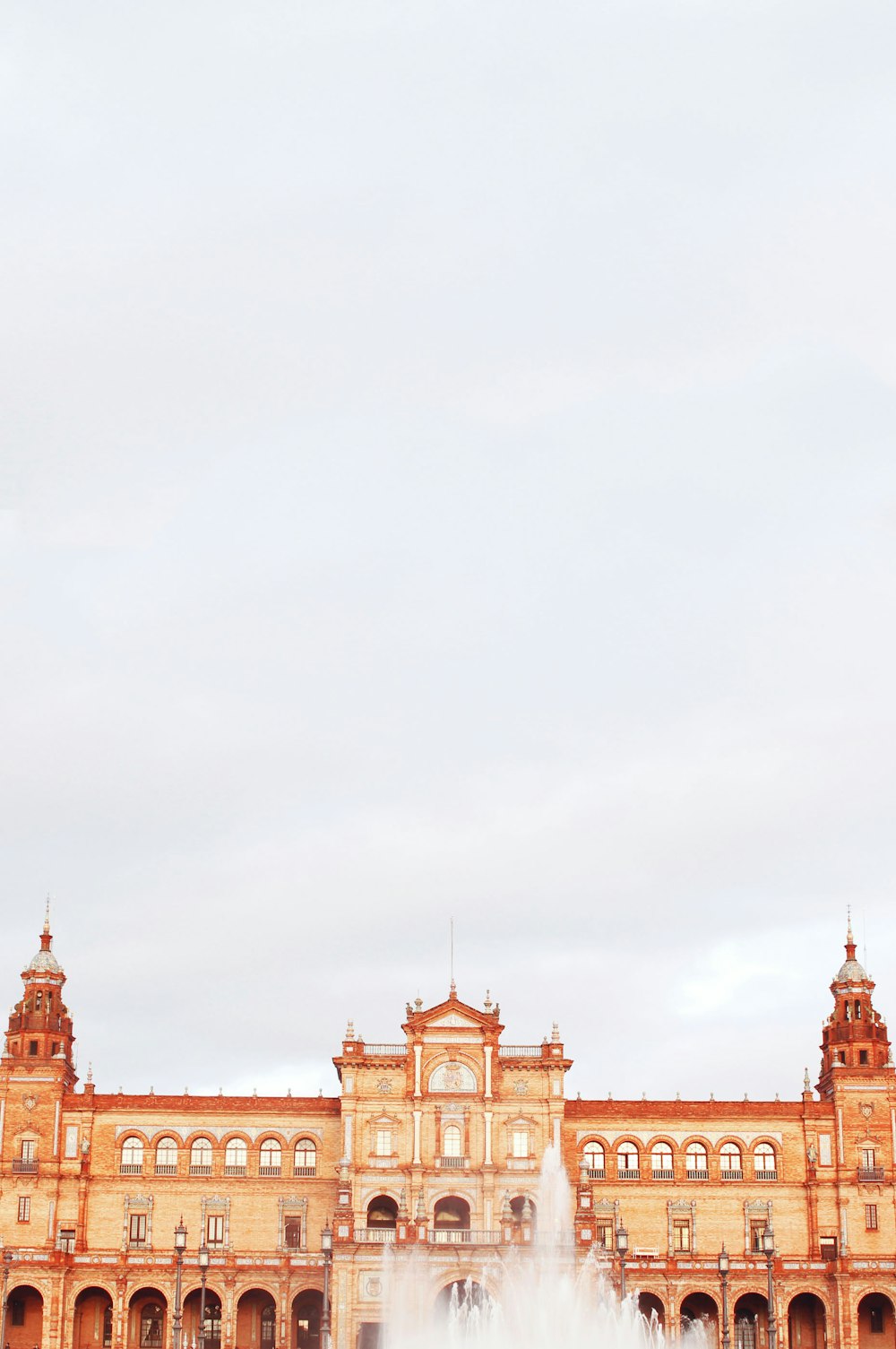 a large building with a fountain in front of it