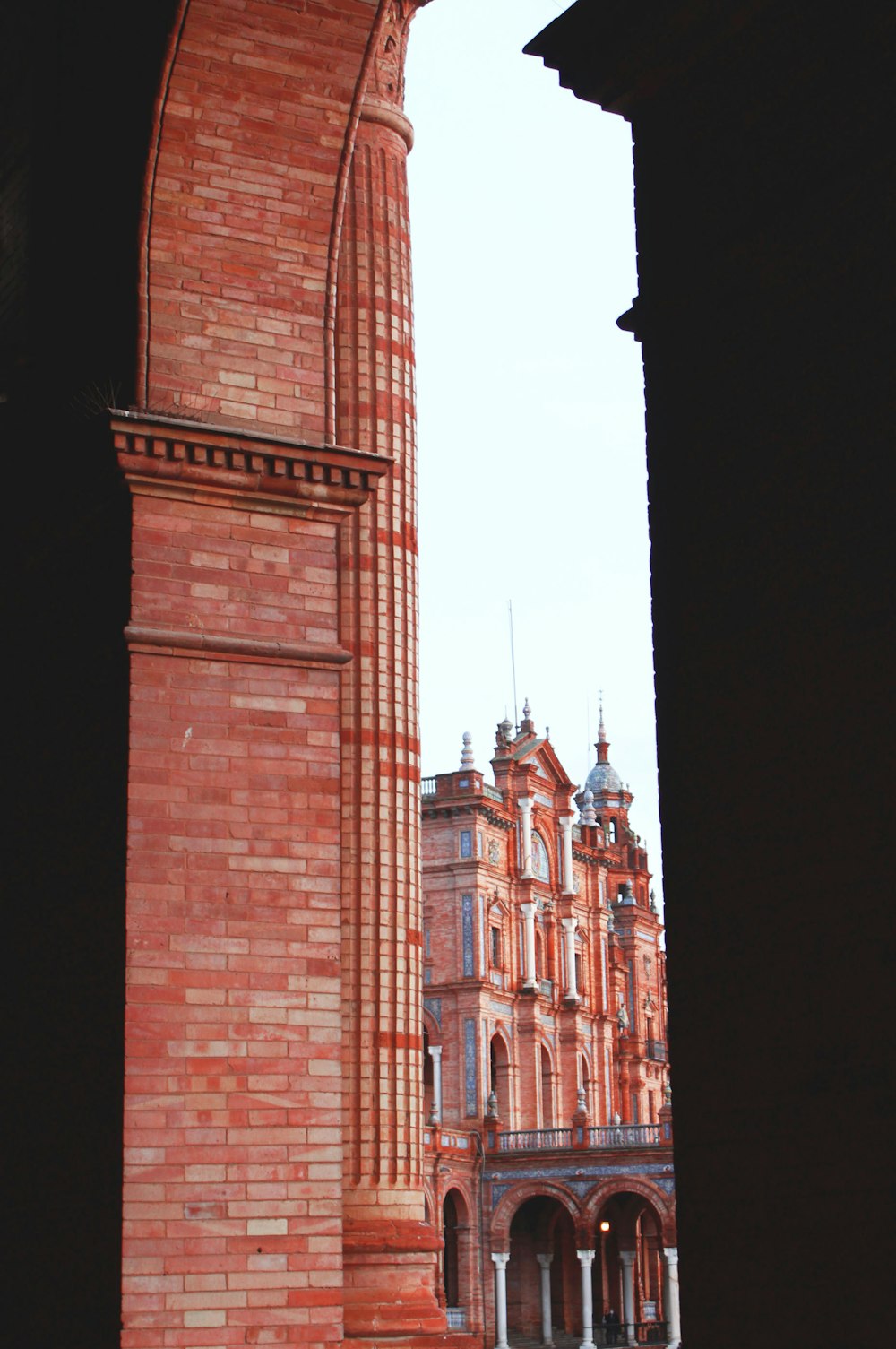 a tall brick clock tower towering over a city