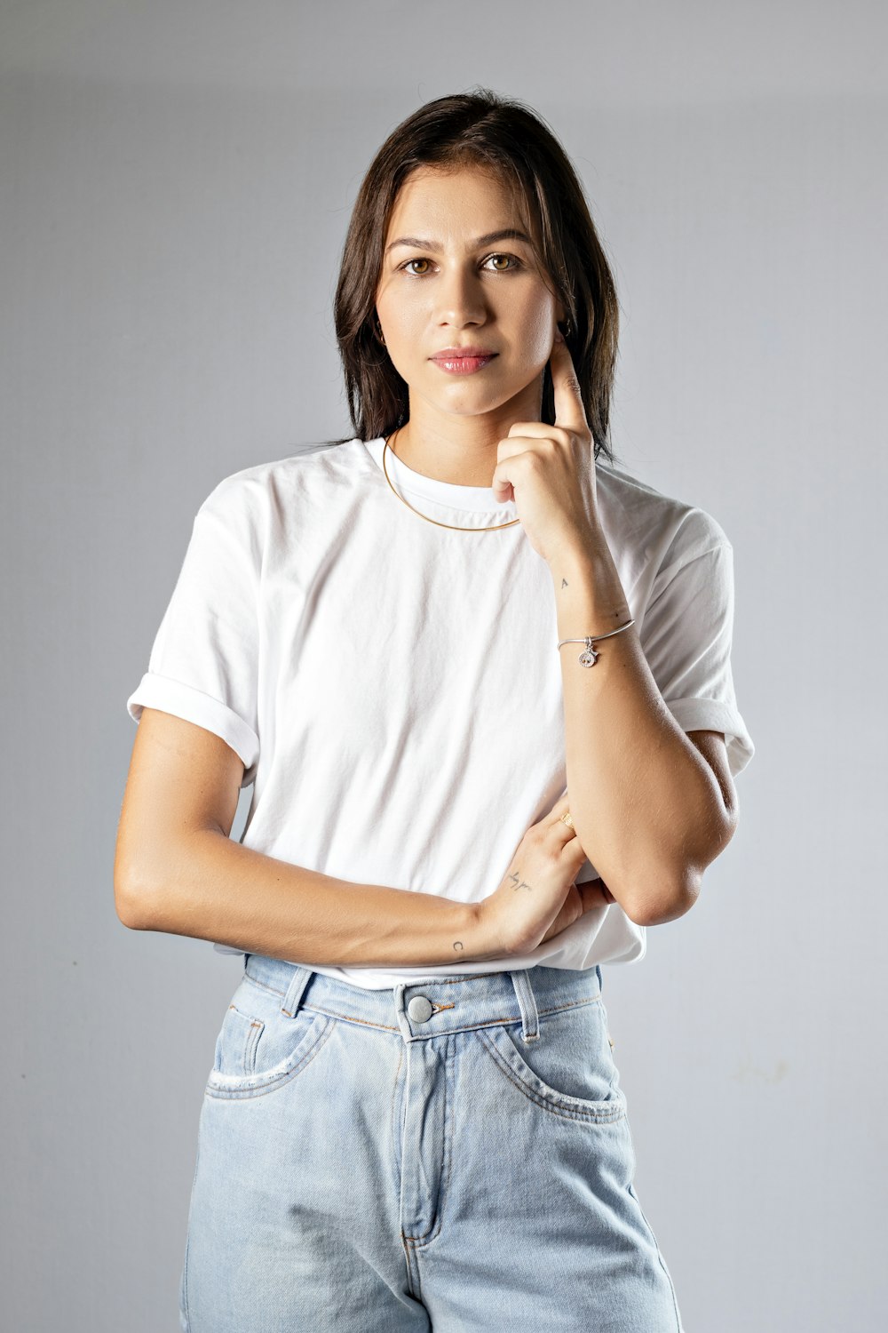 a woman posing for a picture with her hand on her chin