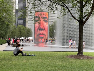 A team of technicians carefully installing a large-scale electronic display outdoors