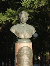 Portrait of Yuskov in a natural outdoor setting, radiating confidence and warmth.