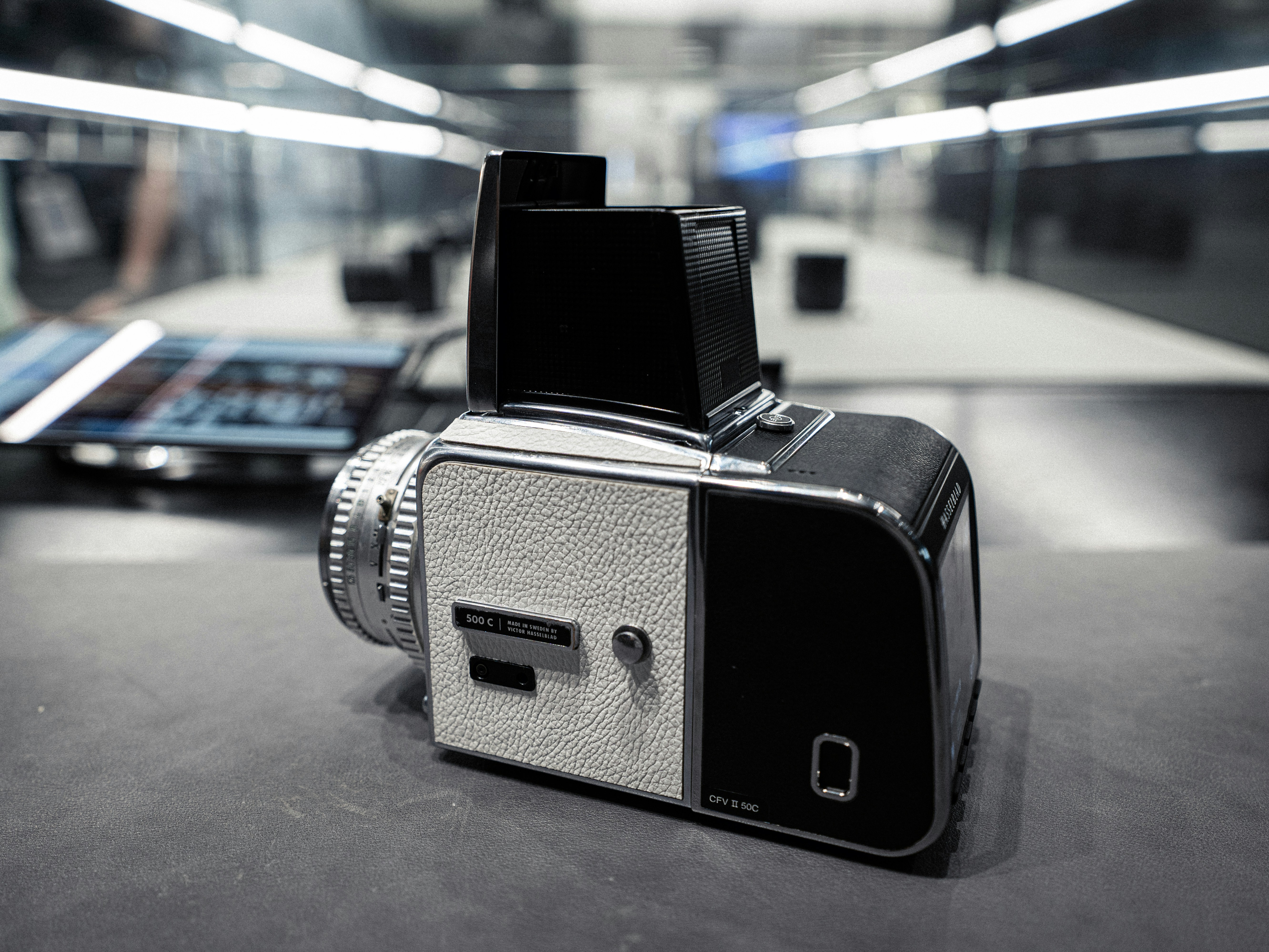 a camera sitting on top of a table next to a cell phone