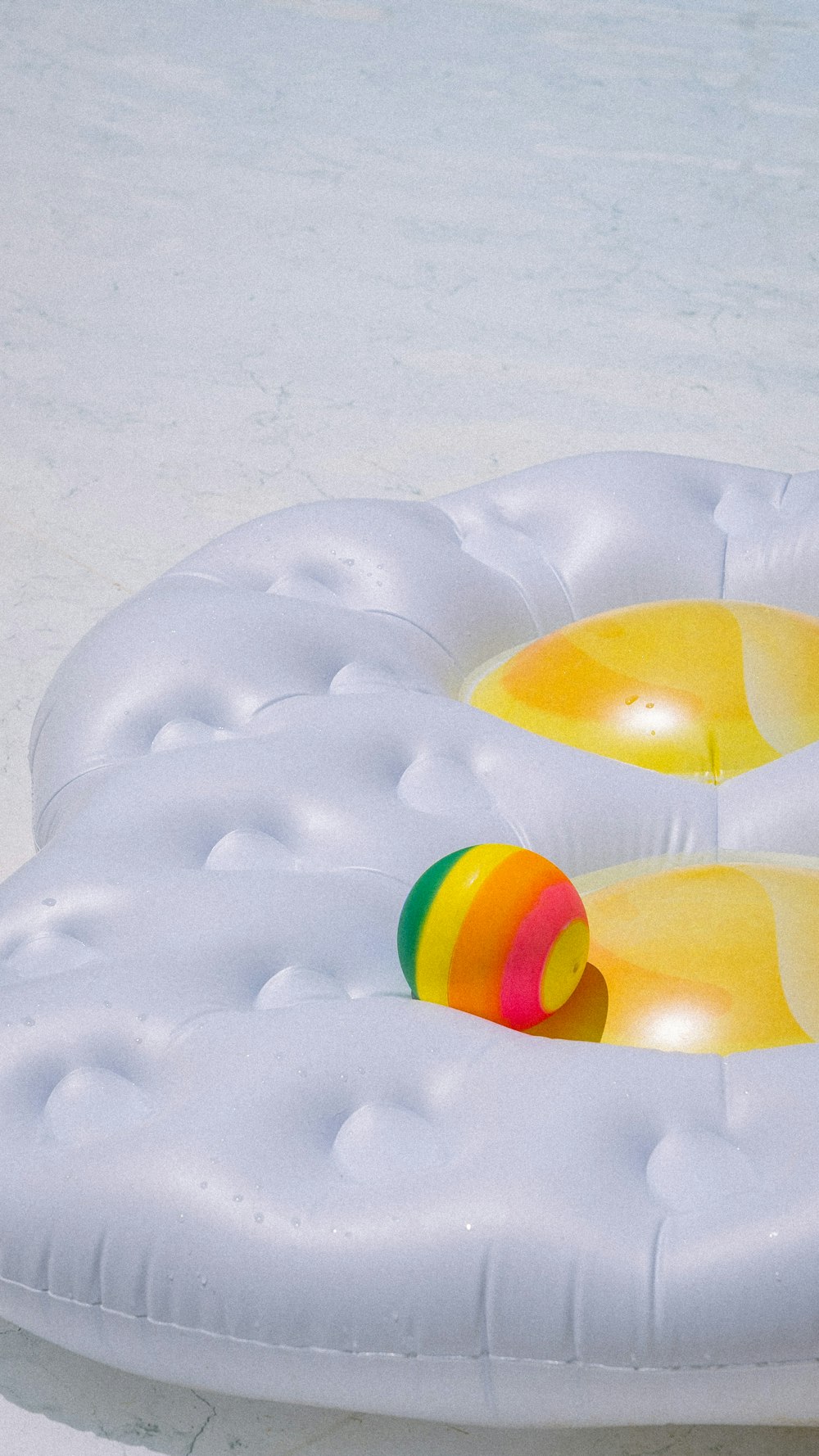 an inflatable pool with a ball on top of it
