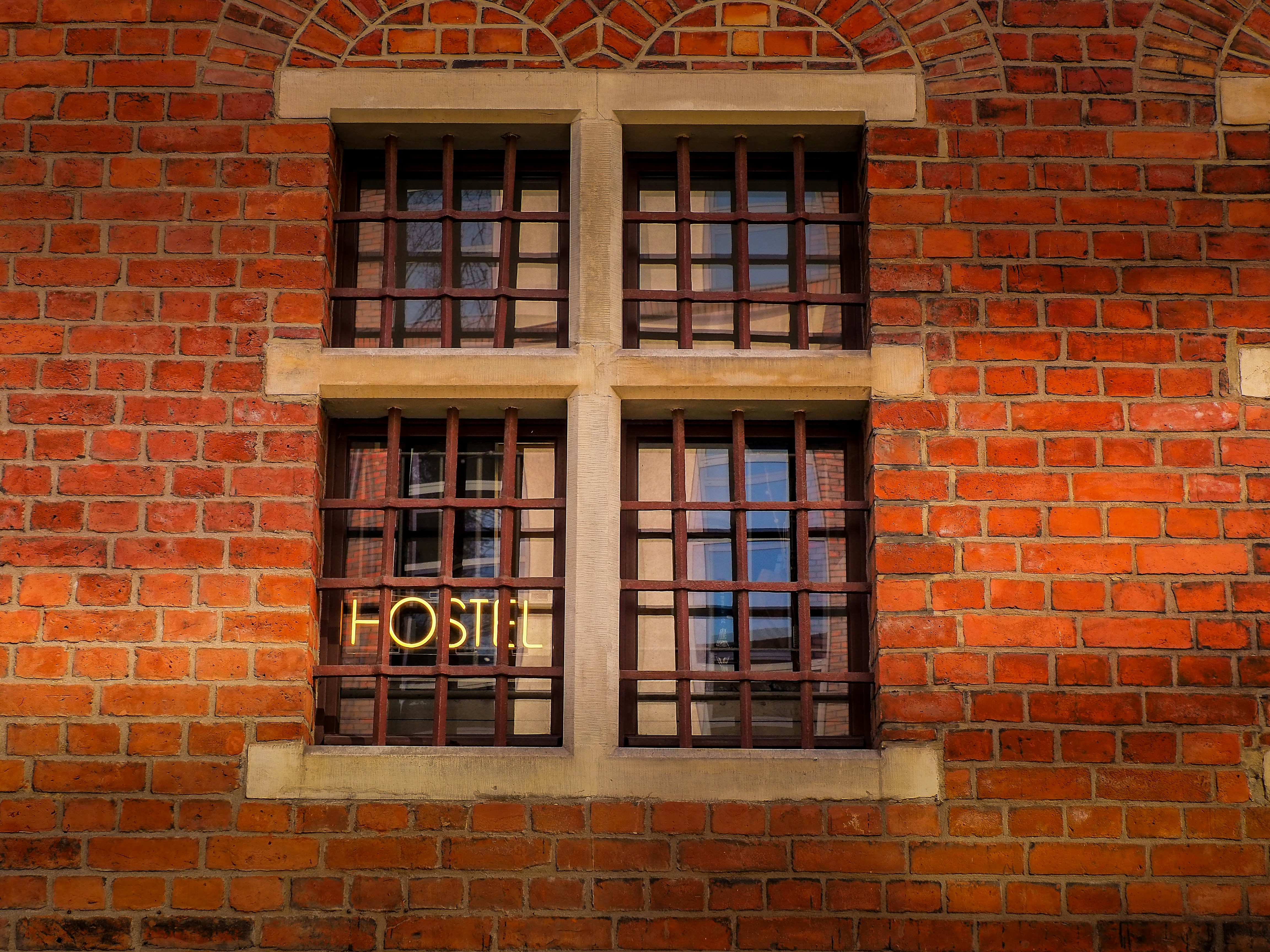 a red brick building with two windows and a sign that reads hotel